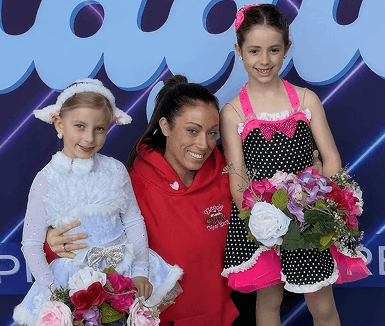 Young Momentum dancers smiling after a performance